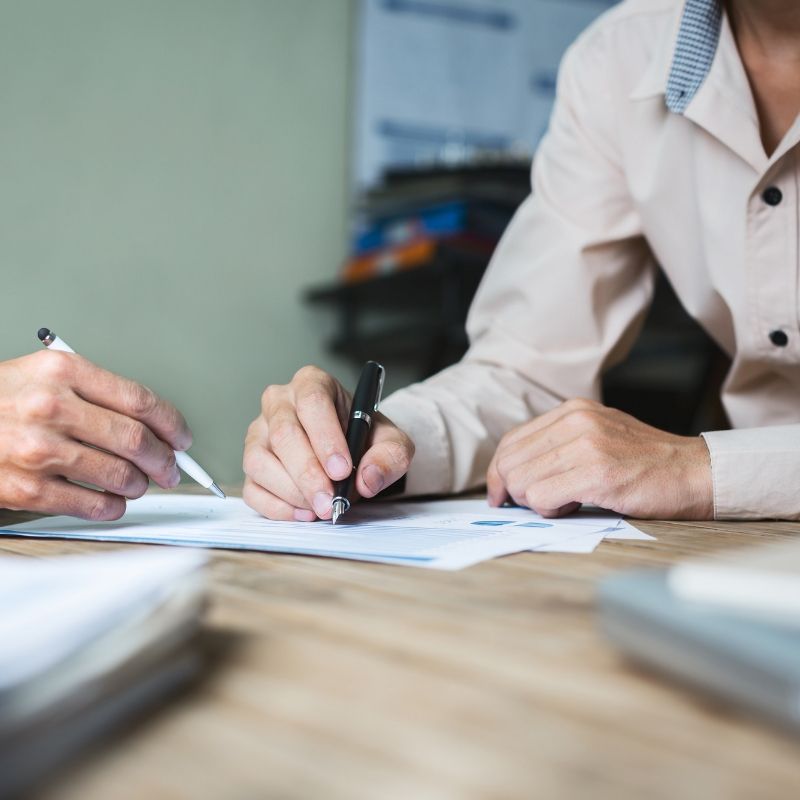 Two people at a table completing paperwork